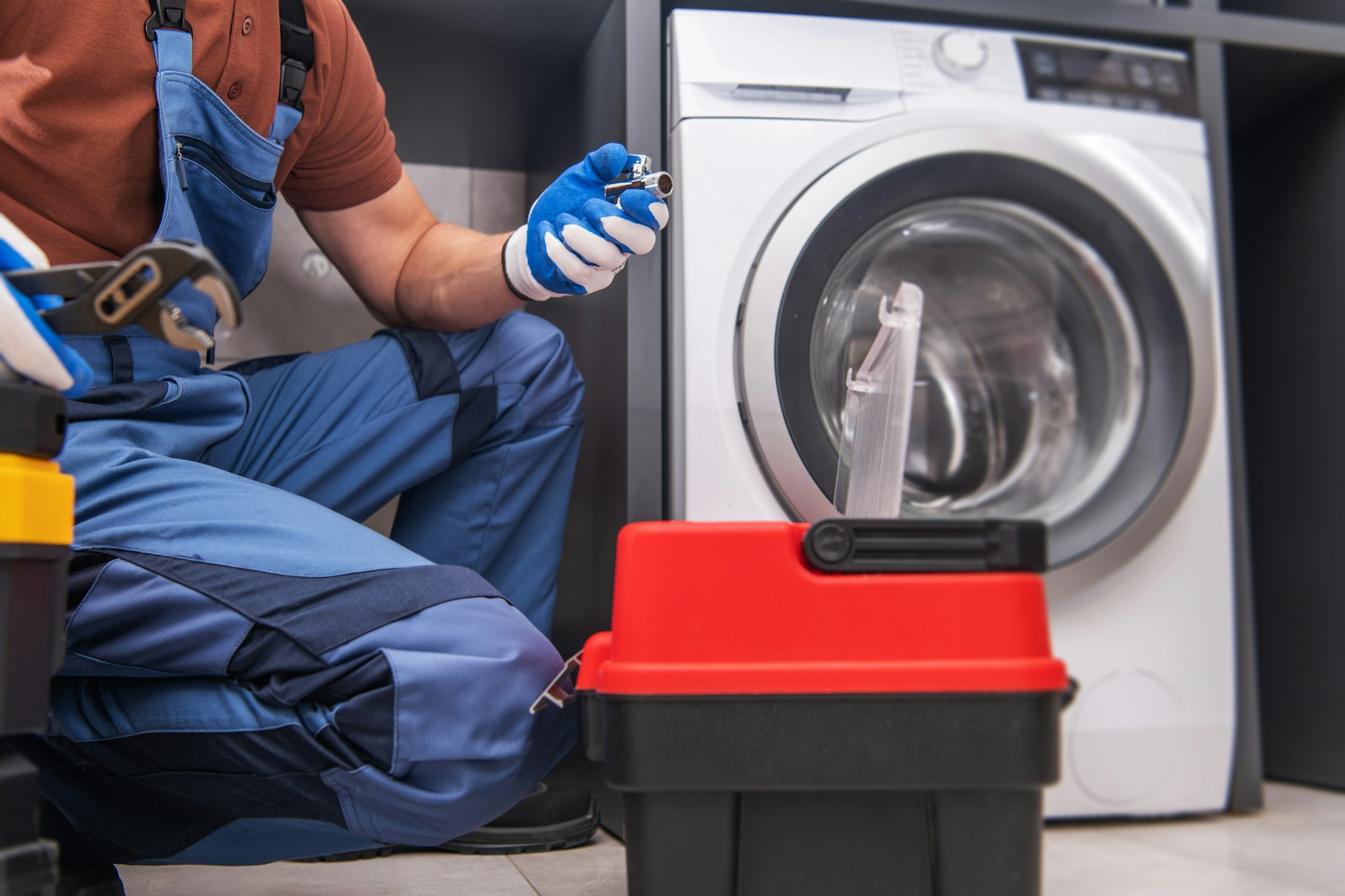 Professional Worker Installing Washing Machine